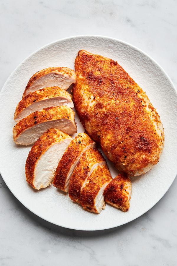 baked chicken sliced on a plate seasoned with salt, pepper, garlic powder, onion powder, paprika & brown sugar