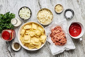 ground italian sausage, onion, garlic, marinara, canned tomatoes, spices, cream and mozzarella and ravioli in prep bowls