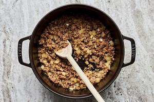 ground Italian sausage, onion, and garlic being cooked in a pot
