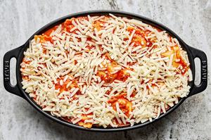 cheese ravioli swimming in a ground Italian sausage marinara sauce topped with mozzarella cheese