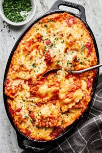 baked ravioli made with ground italian sausage, onion, garlic, marinara, spices, cream and mozzarella topped with parsley