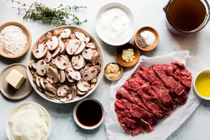 ingredients for homemade beef stroganoff: beef, mushrooms, butter, onion, spices, sour cream, Worcestershire and dijon