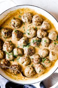 Swedish Meatballs in a pan with a serving spoon