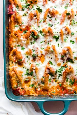 Easy Stuffed Pasta Shells made with ricotta, ground chicken in a pan topped with marinara sauce, mozzarella and parsley