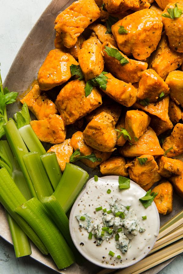 Buffalo Chicken Bites with Blue Cheese Dressing and celery on a plate