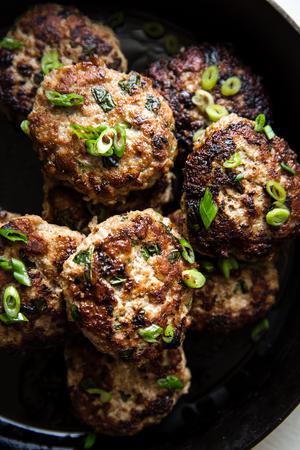 Asian-inspired breakfast turkey patties on a black plate