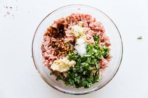 ground turkey, minced garlic, minced ginger, chopped basil, salt, red pepper flakes and chopped green onions in a bowl