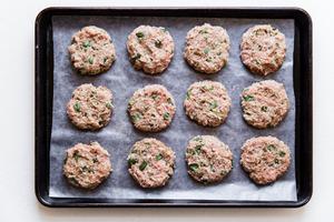 12 Asian inspired breakfast turkey patties formed on a baking sheet