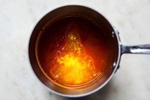 homemade buffalo sauce in a sauce pan made with hot sauce, honey and butter for baked buffalo chicken wings