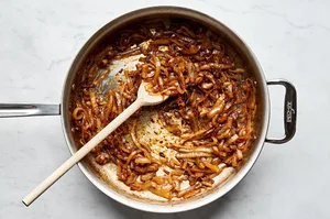 A pan of beautifully caramelized onions, golden and tender, gently sizzling to perfection.