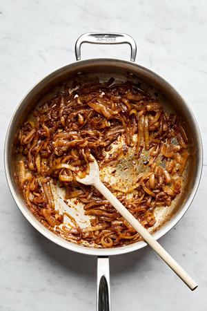 A pan of beautifully caramelized onions, golden and tender, gently sizzling to perfection.