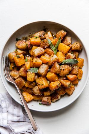 ceramic bowl of brown butter sage cauliflower gnocchi with butternut squash