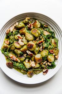 vegan cauliflower gnocchi with Kale-Cashew pesto in a white bowl