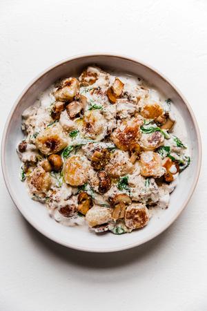bowl of gnocchi alfredo with mushroom sauce