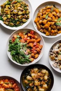 Six recipes of cauliflower gnocchi in various ceramic bowls