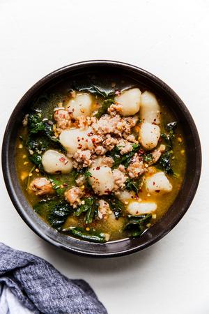 black bowl of cauliflower gnocchi zuppa toscana