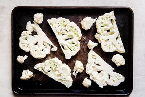 cauliflower steaks sliced on a baking sheet