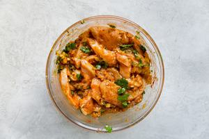 glass bowl with raw chicken in fajita marinade