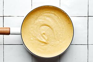homemade polenta in a pot made with milk, chicken stock, butter, parmesan, salt and pepper