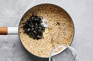 brown rice, vinegar, salt, garlic powder, minced nori and water in a pan to make seasoned sushi rice
