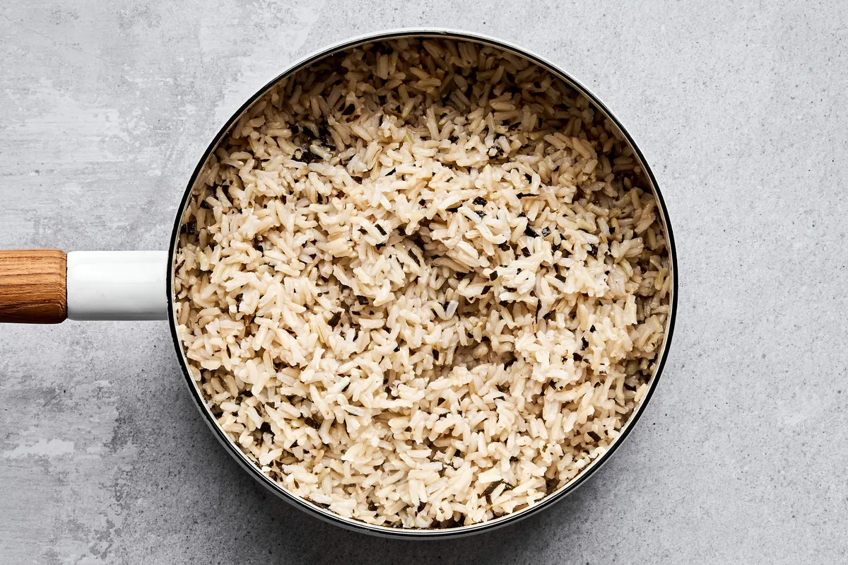 a pot of seasoned sushi rice made with vinegar, salt, garlic powder and minced nori