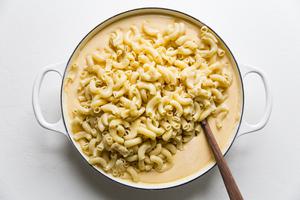 cooked pasta being added to Classic Baked Macaroni And Cheese