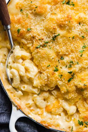 cheddar cheese baked macaroni with a scoop taken out.