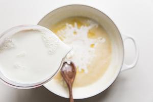 milk being added to butter and flour mixture.