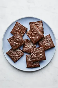 a plate of classic fudge brownies cut into squares, the ultimate cozy chocolatey dessert