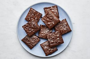 a plate of classic fudge brownies cut into squares, the ultimate cozy chocolatey dessert