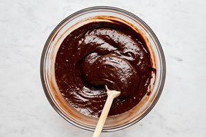 fudgy brownie batter being stirred in a bowl