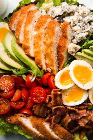 close up of classic cobb salad with crispy panko chicken and buttermilk ranch dressing