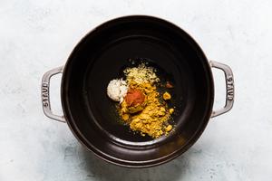 seasoning for coconut curry ramen in a soup pot