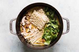 ramen noodles, mushrooms, bok choy added to broth for curry soup