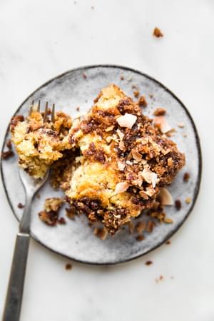 slice of homemade coffee cake on a grey plate with a piece cut out