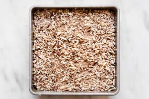 sour cream coffee cake batter topped with pecan coconut crumple topping