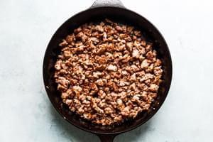 cast iron skillet of cooked ground pork