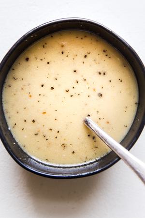 creamy maple salad dressing in a bowl with a spoon
