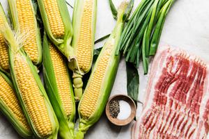 corn on cob, green onions, salt, pepper and raw bacon in prep bowls to make dairy free creamed corn