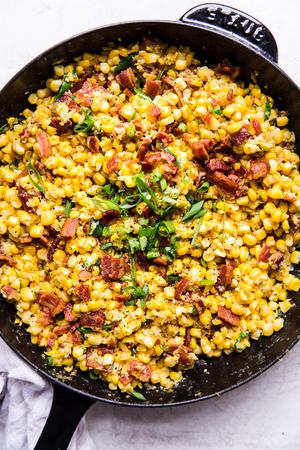 dairy free creamed corn in a skillet made with bacon and green onions