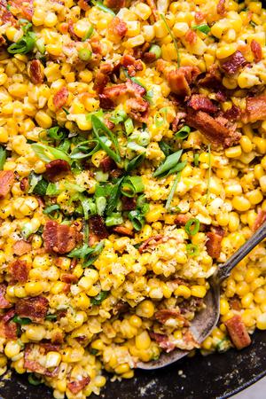dairy free creamed corn in a skillet made with bacon and green onions
