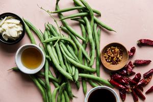 ingredients for Chinese dried fried green beans garlic, peppers, sesame oil, soy sauce