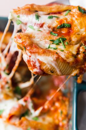 Easy Stuffed Pasta Shells made with ricotta, ground chicken in a pan topped with marinara sauce, mozzarella and parsley