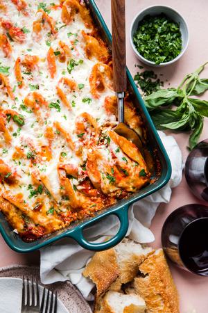 Stuffed Shells made with ricotta and ground chicken in a pan topped with marinara sauce, mozzarella and parsley