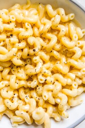 stovetop mac and cheese topped with freshly cracked black pepper