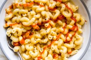 four ingredient stovetop mac and cheese in a bowl topped with Sriracha