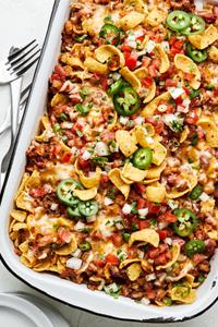 frito pie made with ground beef, kidney & pinto beans, topped with onion, green onion, jalapenos, and pico de gallo