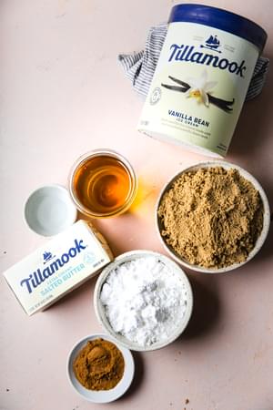 ingredients laid out for hot buttered rum mix vanilla ice cream, butter, brown sugar powdered sugar cinnamon nutmeg