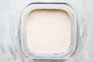 eggs, heavy cream, vanilla extract and cinnamon whisked together in a glass dish on the counter for home made French toast