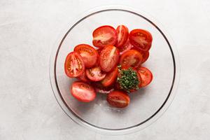 roma tomato halved in a bowl.